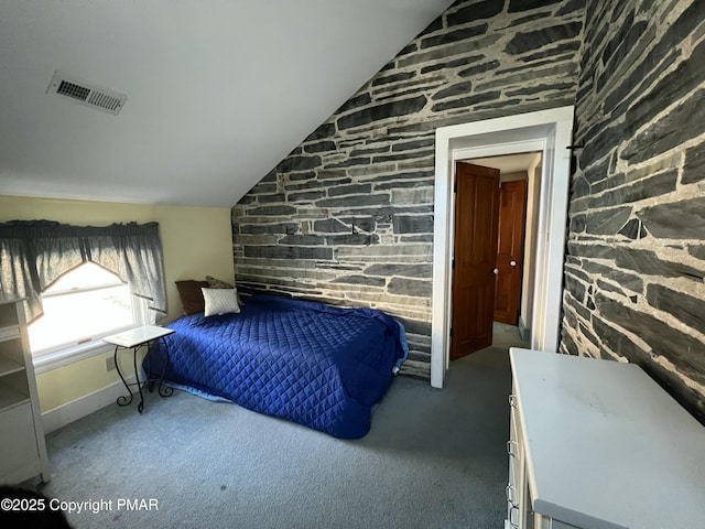 bedroom with carpet floors, visible vents, and vaulted ceiling