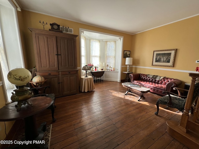 living room featuring ornamental molding and dark wood-style flooring