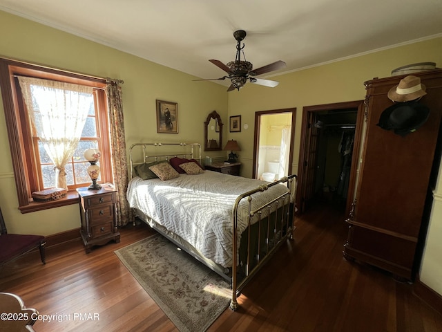 bedroom featuring a closet, ensuite bathroom, ornamental molding, ceiling fan, and wood finished floors