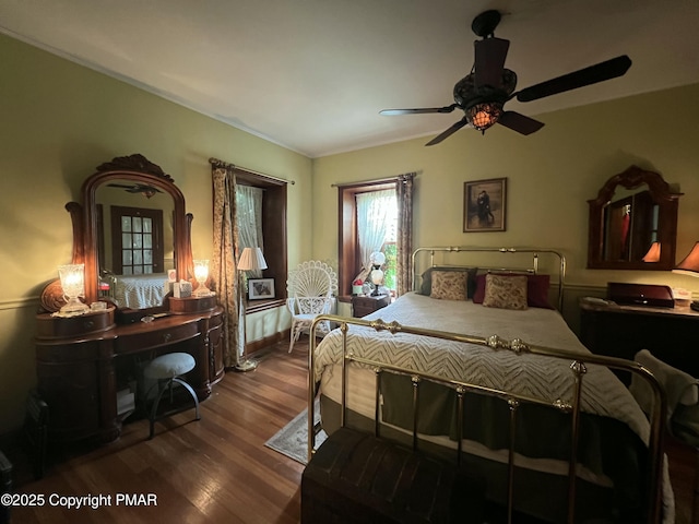 bedroom with ceiling fan and wood finished floors