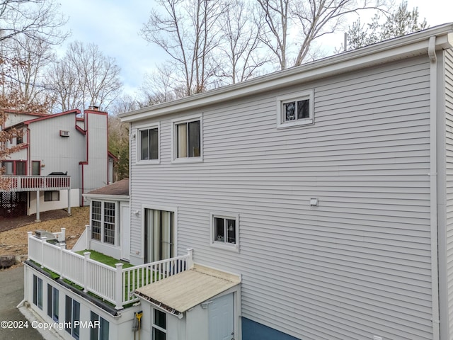 back of house with a wooden deck