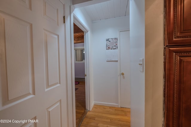 hall featuring baseboards and light wood-style floors