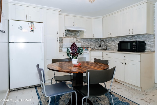 kitchen featuring marble finish floor, light countertops, a sink, white appliances, and under cabinet range hood