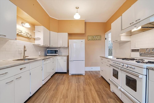 kitchen with light wood-style flooring, a sink, white appliances, and white cabinets