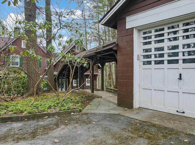 exterior space featuring concrete block siding and a garage