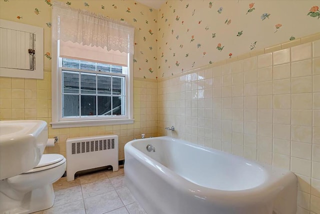 full bath with radiator heating unit, tile patterned floors, tile walls, and wallpapered walls