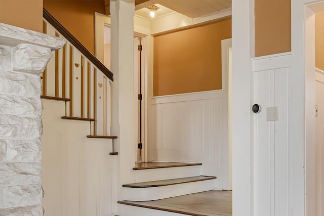 staircase featuring wainscoting