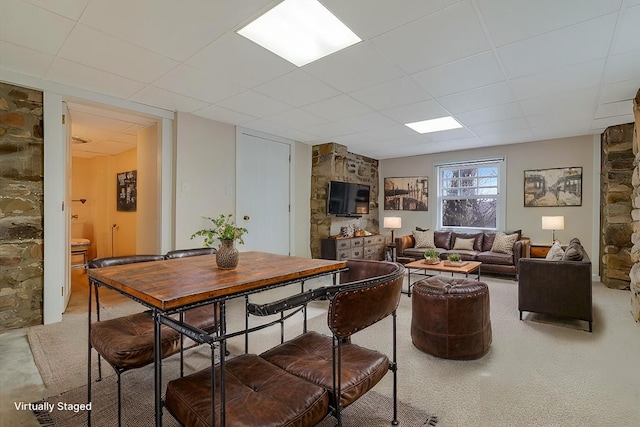 dining room featuring a drop ceiling
