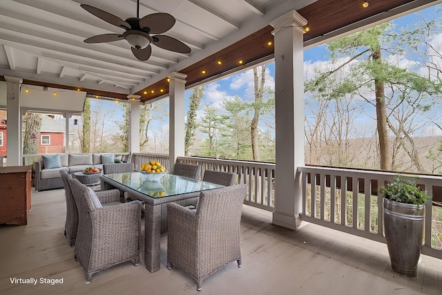 sunroom / solarium featuring beamed ceiling