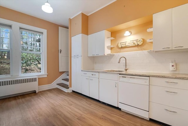 kitchen featuring backsplash, open shelves, radiator heating unit, dishwasher, and a sink