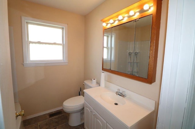 bathroom with a healthy amount of sunlight, vanity, toilet, and visible vents