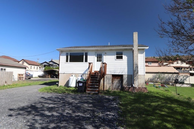 back of house featuring fence and a yard