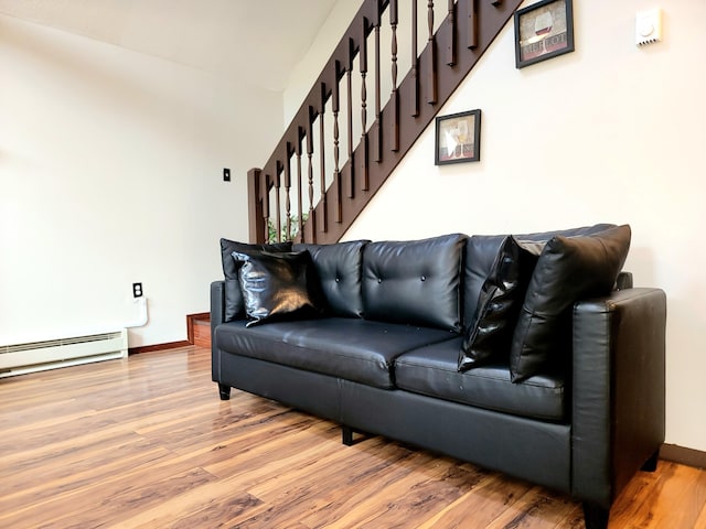 157 Seminole Trl, Tobyhanna, PA 18466 - living area featuring wood finished floors, baseboards, stairway, and a baseboard heating unit