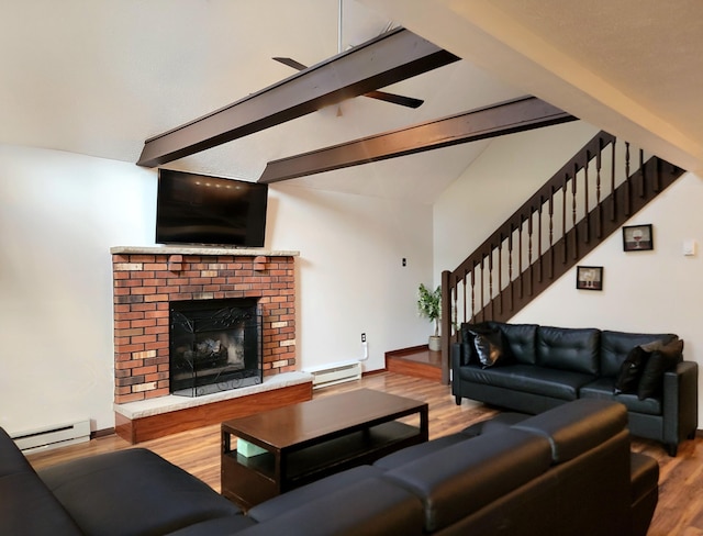 157 Seminole Trl, Tobyhanna, PA 18466 - living room with a baseboard radiator, stairs, wood finished floors, and a fireplace