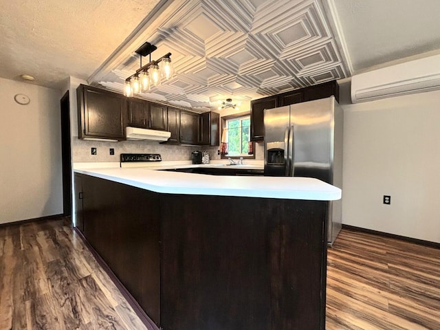 157 Seminole Trl, Tobyhanna, PA 18466 - kitchen with under cabinet range hood, stainless steel refrigerator with ice dispenser, a wall unit AC, dark wood finished floors, and an ornate ceiling