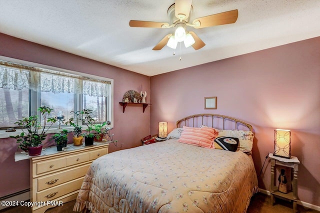 bedroom with a baseboard heating unit and ceiling fan