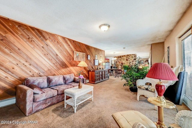 living area featuring light carpet, wood walls, and a baseboard radiator