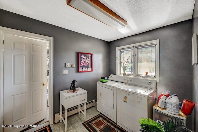 laundry room with a baseboard heating unit, laundry area, and washer and dryer