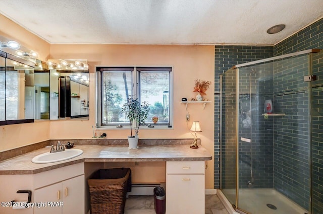 bathroom featuring a textured ceiling, a baseboard radiator, a shower stall, and vanity