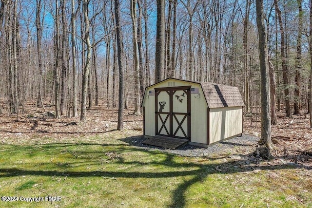 view of shed with a view of trees