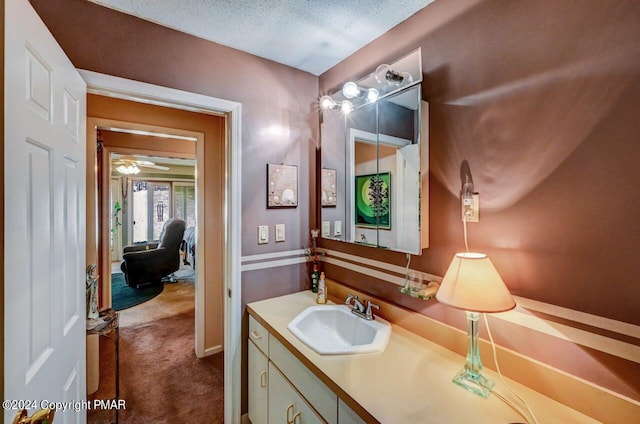 bathroom with a textured ceiling and vanity