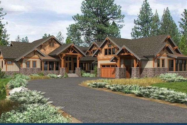 view of front of property with a garage, aphalt driveway, and stone siding