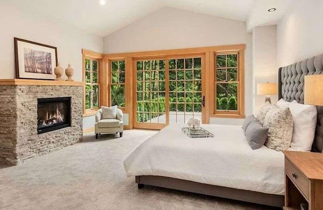 bedroom featuring carpet floors, access to exterior, a fireplace, and lofted ceiling