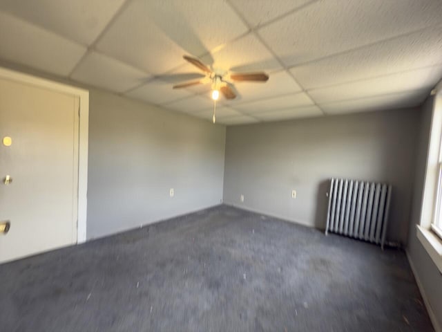 80 Parsonage St Rear, Rear, Pittston, PA 18640 - empty room with radiator, a drop ceiling, ceiling fan, dark colored carpet, and baseboards