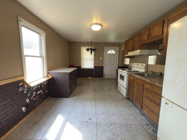 80 Parsonage St Rear, Rear, Pittston, PA 18640 - kitchen with white appliances, wainscoting, brown cabinetry, light tile patterned floors, and a sink
