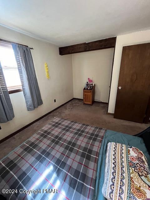 unfurnished bedroom featuring carpet and baseboards