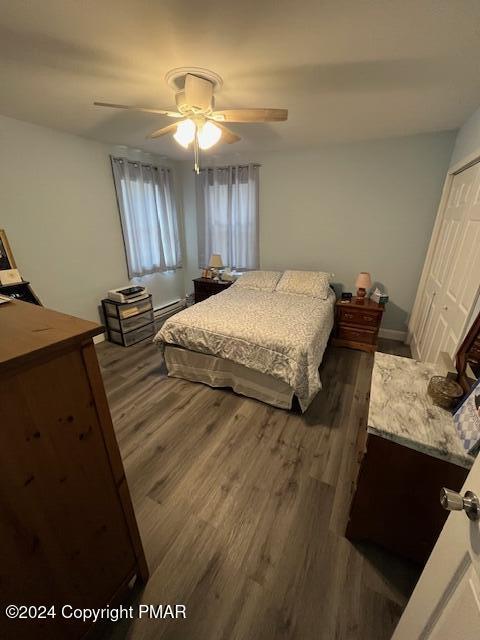 bedroom featuring ceiling fan and wood finished floors