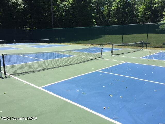 view of tennis court featuring fence