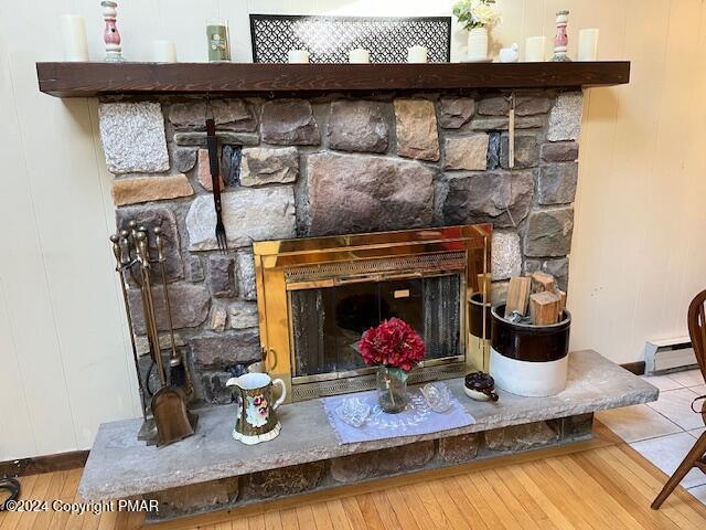 interior details with a fireplace and wood finished floors