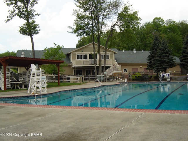 pool featuring a patio area and stairway