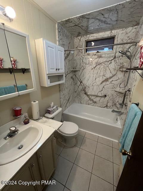 bathroom with tile patterned flooring, tub / shower combination, vanity, and toilet