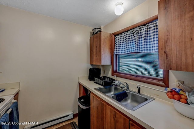 kitchen featuring brown cabinets, a sink, a baseboard heating unit, white electric range oven, and light countertops