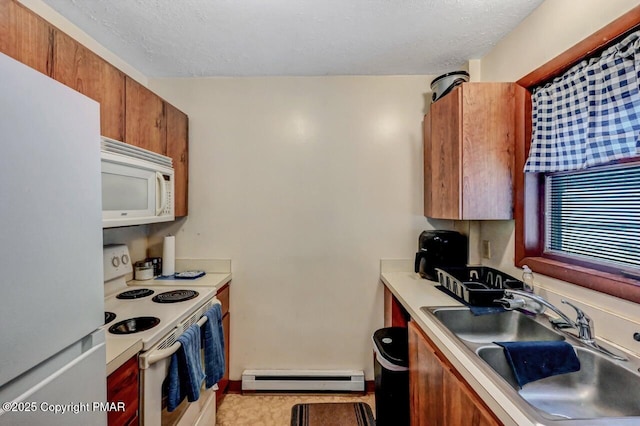 kitchen with light countertops, baseboard heating, white appliances, a textured ceiling, and a sink