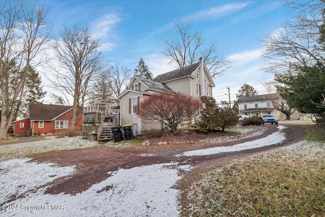 view of snow covered exterior with a deck