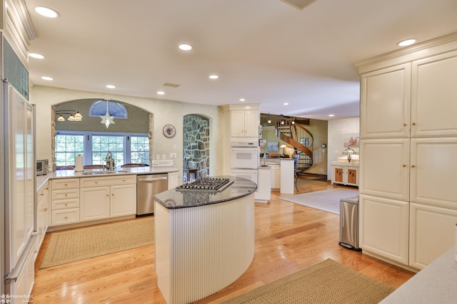 2711 Main St, Bethlehem, PA 18017 - kitchen with appliances with stainless steel finishes, a kitchen island, light wood-type flooring, a chandelier, and recessed lighting