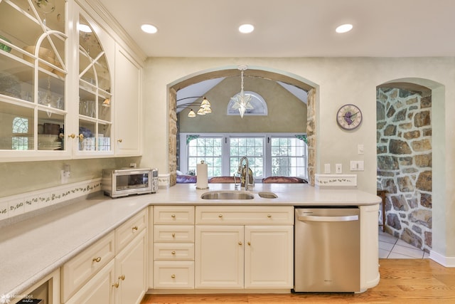 2711 Main St, Bethlehem, PA 18017 - kitchen featuring stainless steel dishwasher, glass insert cabinets, light countertops, arched walkways, and recessed lighting