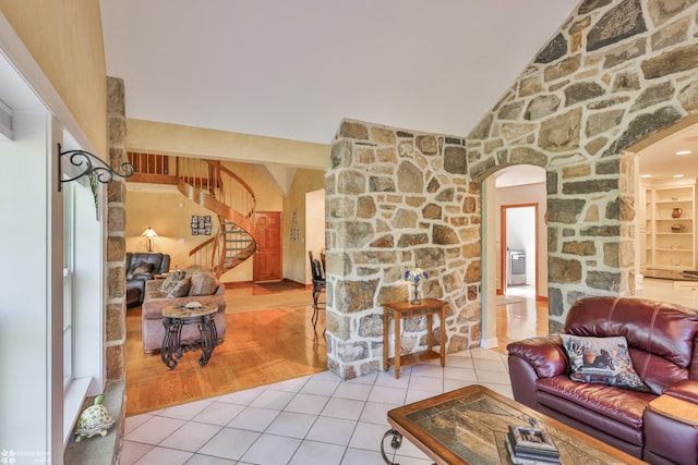 2711 Main St, Bethlehem, PA 18017 - tiled living room with stairway, arched walkways, and lofted ceiling