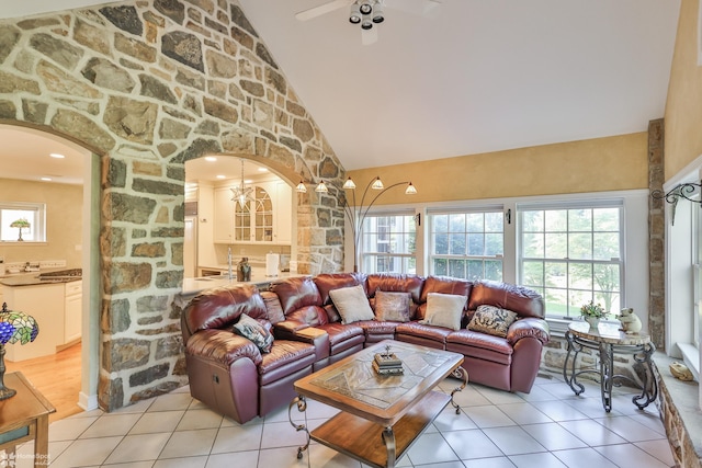 2711 Main St, Bethlehem, PA 18017 - living room featuring arched walkways, high vaulted ceiling, light tile patterned floors, and healthy amount of natural light