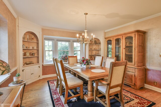 2711 Main St, Bethlehem, PA 18017 - dining room with light wood-type flooring, a chandelier, built in features, and crown molding