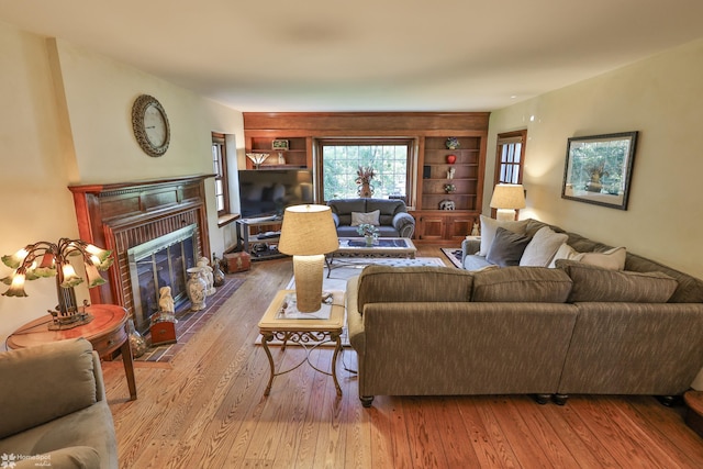 2711 Main St, Bethlehem, PA 18017 - living area featuring hardwood / wood-style flooring, built in shelves, and a brick fireplace