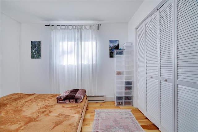 9379 Fairmount Way, Tobyhanna, PA 18466 - bedroom with a baseboard radiator, light wood-style flooring, and a closet