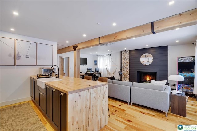 9379 Fairmount Way, Tobyhanna, PA 18466 - kitchen with light wood-type flooring, wood counters, a large fireplace, open floor plan, and recessed lighting