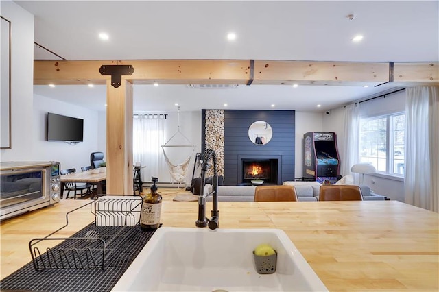 9379 Fairmount Way, Tobyhanna, PA 18466 - kitchen with a fireplace, wood finished floors, light countertops, open floor plan, and recessed lighting