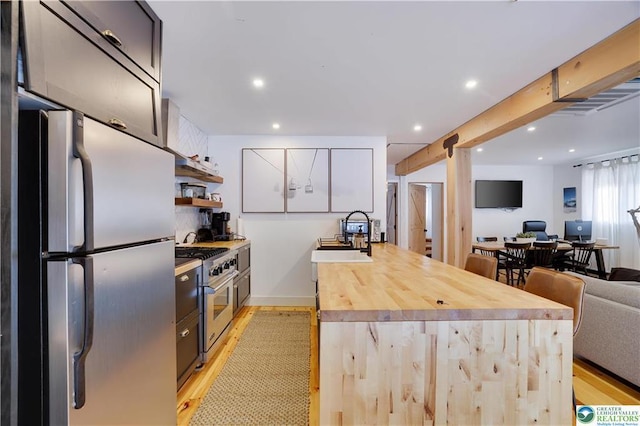 9379 Fairmount Way, Tobyhanna, PA 18466 - kitchen with appliances with stainless steel finishes, light wood-type flooring, open floor plan, a peninsula, and recessed lighting