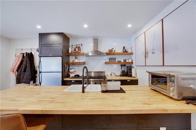 9379 Fairmount Way, Tobyhanna, PA 18466 - kitchen featuring wall chimney exhaust hood, freestanding refrigerator, wood counters, open shelves, and recessed lighting