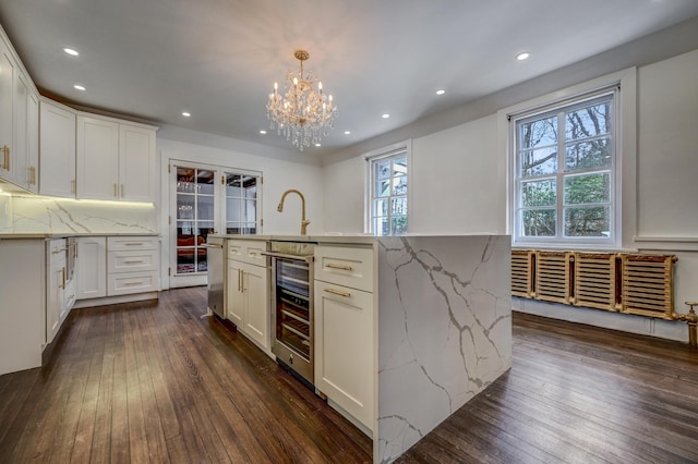 24 Summit Ave, Pocono Summit, PA 18346 - kitchen with dark wood-style floors, tasteful backsplash, wine cooler, and white cabinets
